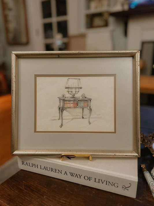 Vintage pencil sketch of a side table with lamp and books. Signed.